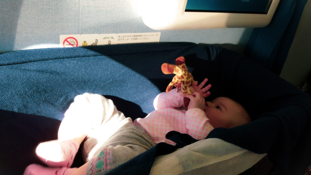 baby in airplane bassinet bulkhead seat travel
