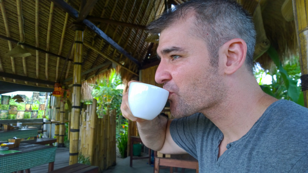 man drinking kopi luwak from mug things to do in bali with toddler