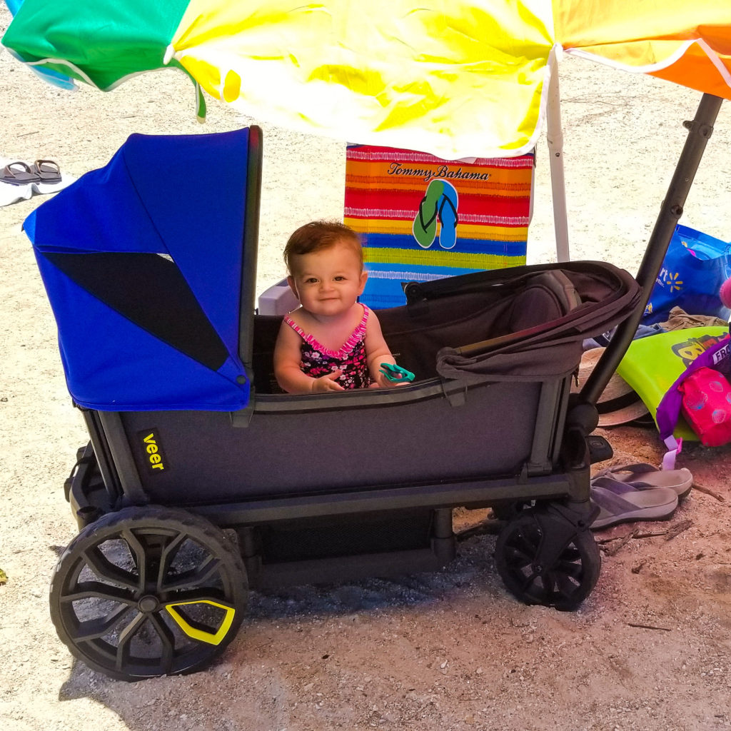 baby in veer cruiser at the beach