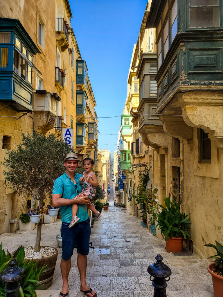 man and toddler in malta valletta street view