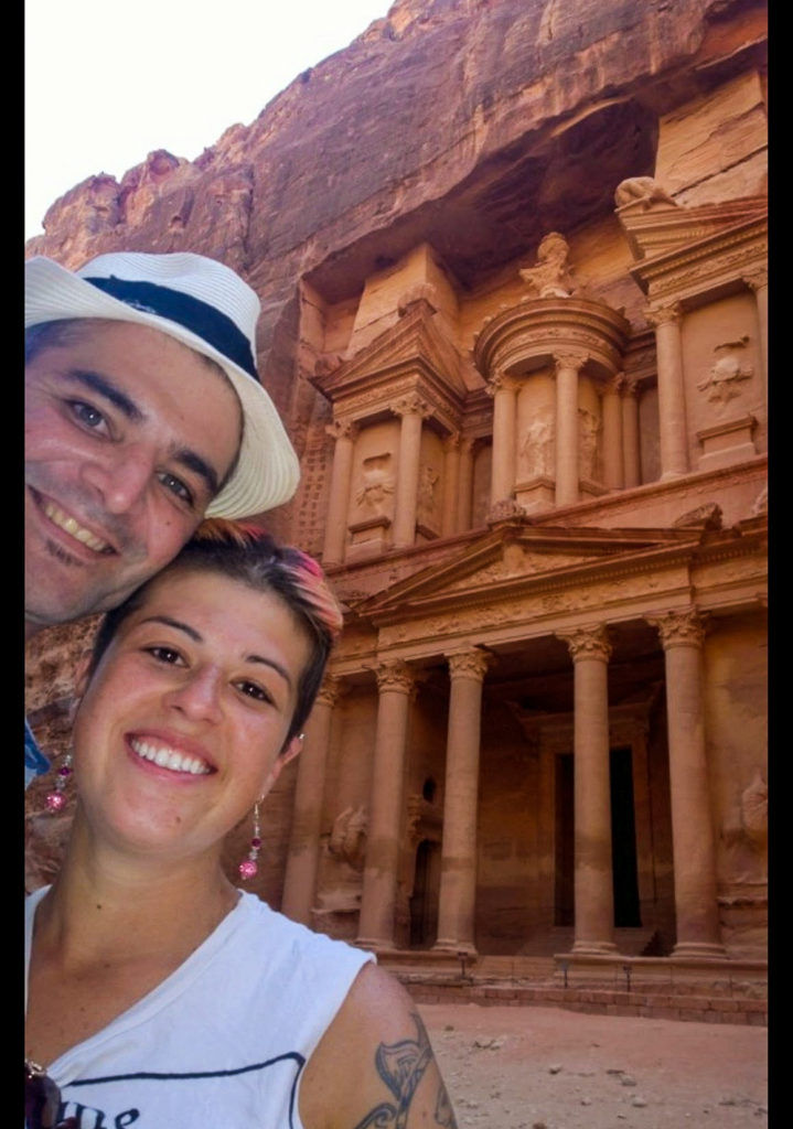 man and woman in front of the main entrance of petra
