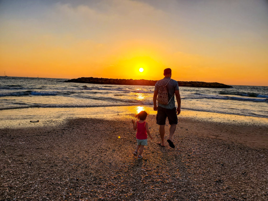 man and toddler in sunset at beach in tel aviv israel with kids