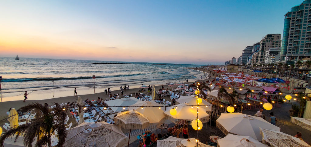view of beach and restaurants out over the tel aviv promenade