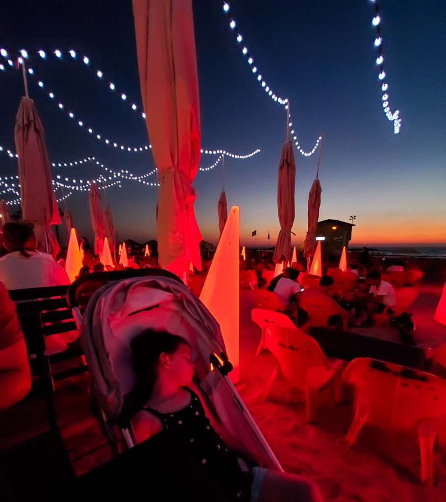 toddler sleeping in mood lit beach club