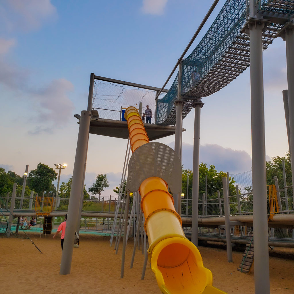 very tall slide with tiny people at top