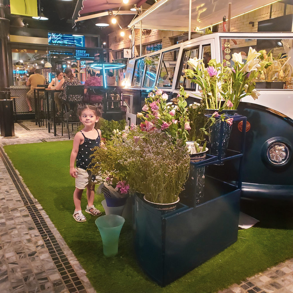 toddler looking at van of flowers in sarona market