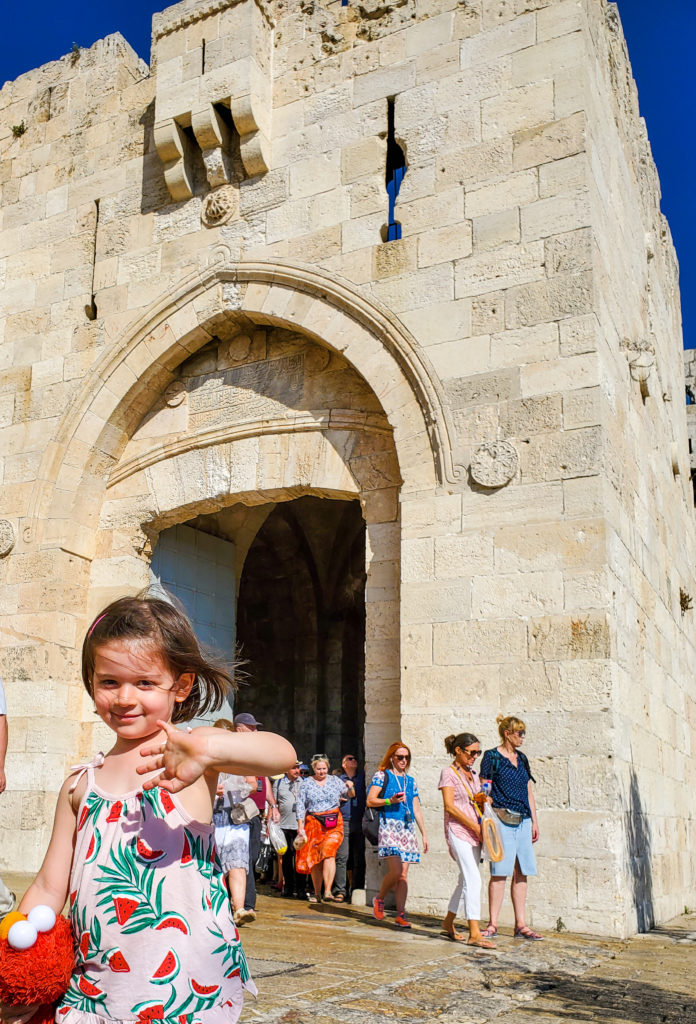 toddler in front of ancient gate