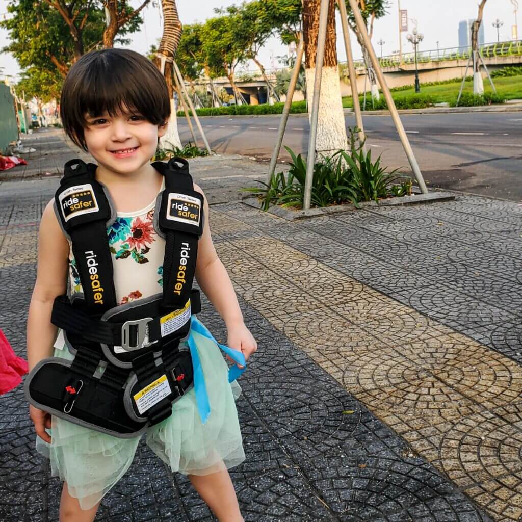 smiling child wearing ride safer travel vest