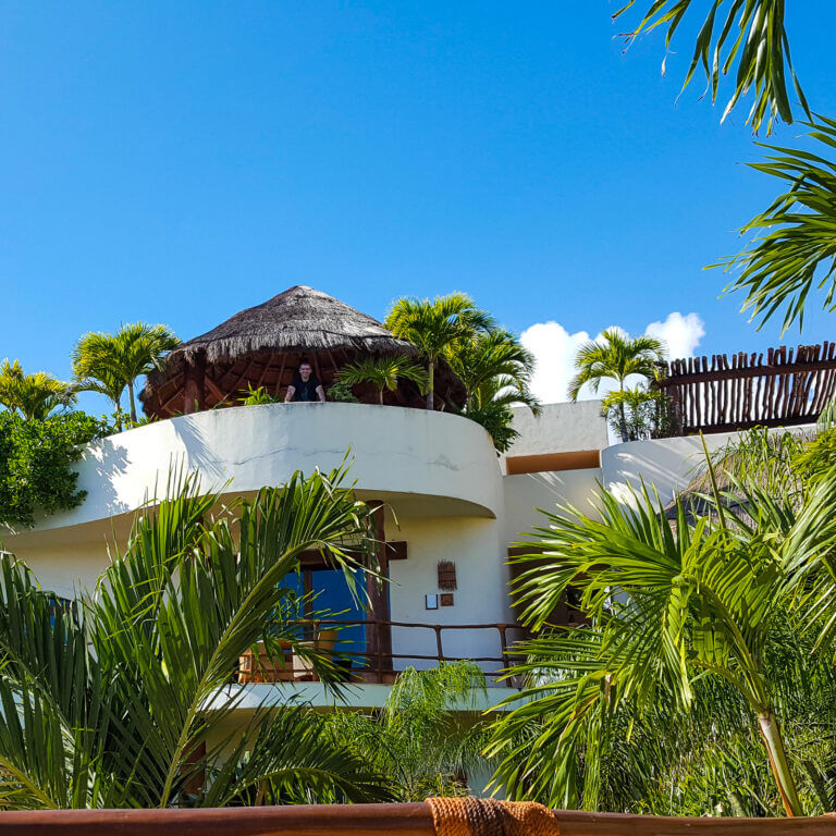 man standing on top floor of penthouse airbnb in playa del carmen mexico