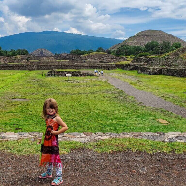 toddler girl standing in front of ruins of teotihuacan